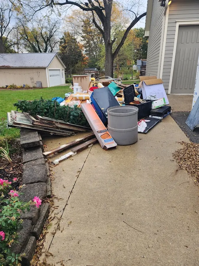 Dumpster being loaded with debris for Commercial Dumpster Rental in Oakwood